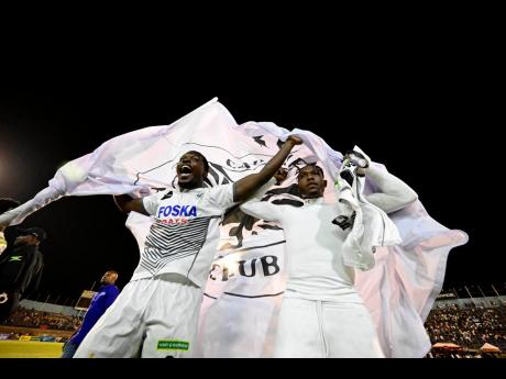 Members of the Cavalier football team celebrate after their 4-3 penalty shoot-out win over defending champions Mount Pleasant in the Jamaica Premier League final at the National Stadium on Sunday night.