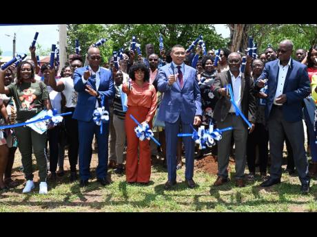 Prime Minister Andrew Holness takes part in the ceremony to hand over land to new owners in phase one of the Friendship Oaks  Housing Development in St Elizabeth on May 17. 
