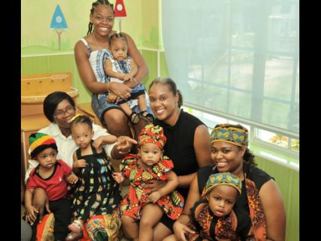 JMMB nursery caregiver, Charmaine Brown (left), with tiny tots – Romani Anderson, Amanda Lawrence, Miya Johnson, Aziel Maxwell and Nikayla Gordon. Mothers, Tavia Daley (back row), Melissa Wilson and Monique Ashley join in saluting ‘Mama Africa’ in th
