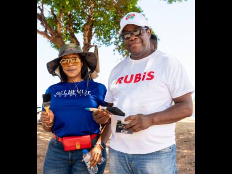 Donnovan Dobson, human resource manager at RUBiS Energy Jamaica, poses for a quick pic with Suzette Buchanan, chief executive officer, Bellevue Hospital, before they begin painting on Labour Day. RUBiS contributed paints and supplies valued at $400,000 tow
