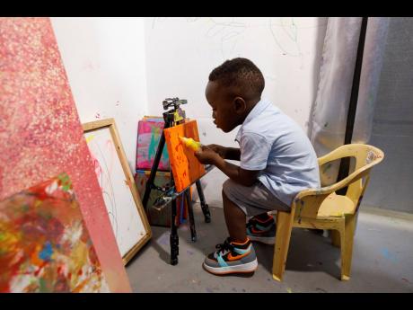 Ace-Liam Nana Sam Ankrah, who will turn two in July, paints at his mother’s art gallery in Accra, Ghana on May 27. Ankrah has set the record as the world’s youngest male artist. 
