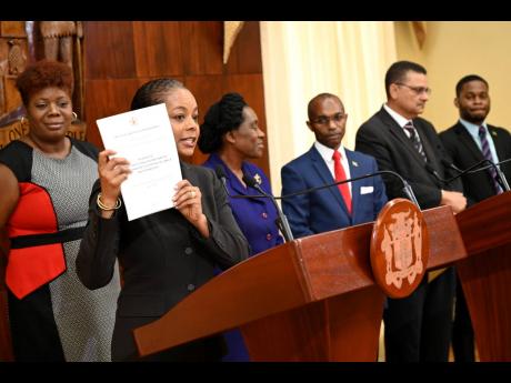 
Marlene Malahoo Forte, (second left) minister of local and constitutional affairs, speaks at a post-Cabinet press briefing as (from left) members of the Constitutional Reform Committee, Nadeen Spence, Elaine McCarthy, Rocky Meade, Derrick McKoy, and Sujae
