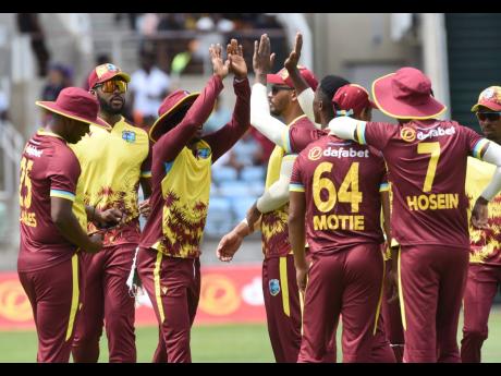 Ian Allen/photographer 
West Indies players celebrate the dismissal of South Africa’s Quinton de Kock during the third T20 International between the teams at Sabina Park on May 26.