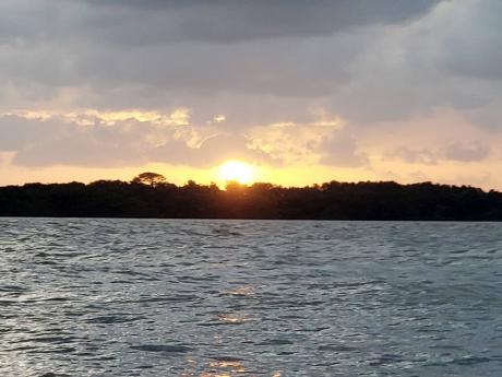 Watching the sun plunge over the western horizon from the Demerara River.