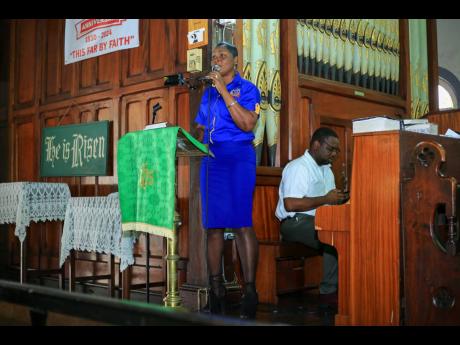 A member of the P.A. Benjamin team performs a song during the church service. 