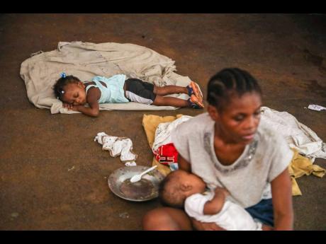 A child sleeps at a shelter housing people who fled their homes due to gang violence in Port-au-Prince, Haiti, on May 27.