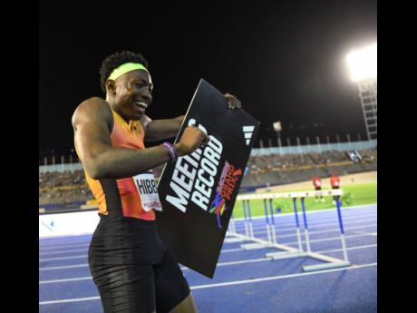 Credit: Gladstone Taylor/Multimedia Photo Editor Jaydon Hibbert is all smiles as he gets ready to hold aloft the Racers Grand Prix meet record sign board after a leap of 17.75 metres at the event at the National Stadium on Saturday.