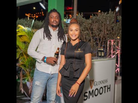 Photographer Ajaun Burton (left) opted for a Guinness Smooth as he posed with Brand Ambassador Makeda Ricketts.