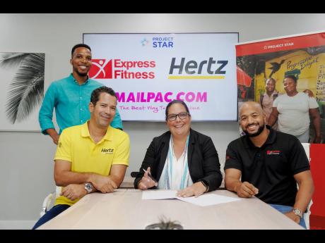 Saffrey Brown (centre), director of Project STAR, signs a partnership agreement with representatives of Norbrook Equity Partners, Nicholas Lynch (left), chief executive officer of Hertz, and Omar Shoucair, chief operating officer of Express Fitness Group. 