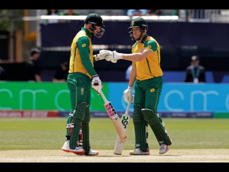 South Africa’s Heinrich Klaasen (left) and David Miller fist bump each other during an ICC Men’s T20 World Cup cricket match against Bangladesh at the Nassau County International Cricket Stadium in Westbury, New York, Monday, June 10, 2024.  