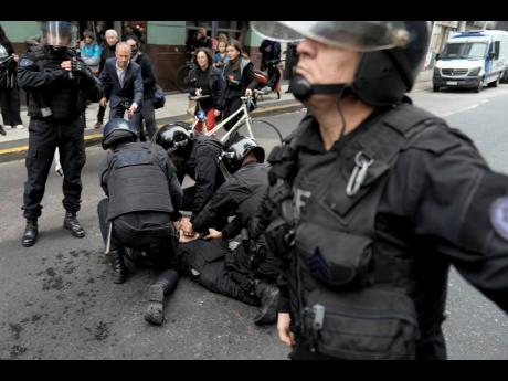 Police detain an anti-government protester outside Congress where lawmakers debate a reform bill promoted by Argentine Javier Milei in Buenos Aires, Argentina, yesterday.