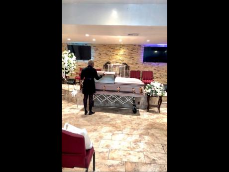 Credit: Contributed Christina Millwood-Nicholson, funeral director and owner of Unique Mortuary Supplies, carrying out a funeral at the morgue.