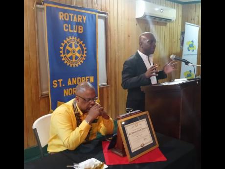 Audley Gordon, executive director of the National Solid Waste Management Authority, addresses the Rotary Club of St Andrew North, while Kirk Crichton, outgoing president, listens.