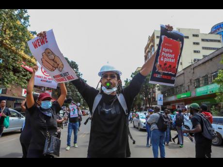 Demonstrators protest against proposed tax hikes in a finance bill that is due to be tabled in parliament in Nairobi, Kenya, yesterday. 