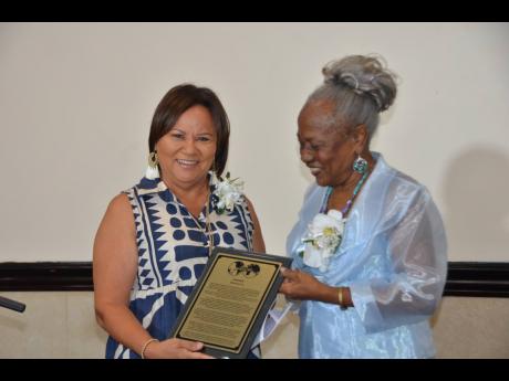 Honey Bun CEO Michelle Chong (left) receives a citation from Business and Professional Women’s Club (BPW) St Andrew President Dr Lilieth Nelson during the recent BPW St Andrew 50th anniversary awards luncheon held at the Jamaica Pegasus Hotel. Chong, who