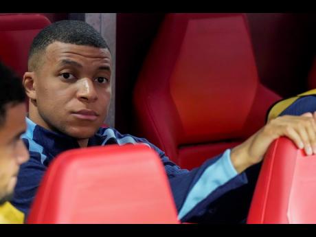 Kylian Mbappe of France looks out from the bench before a Group D match between the Netherlands and France at the Euro 2024 soccer tournament in Leipzig, Germany yesterday.