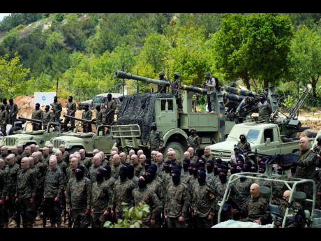 In this May 2023 photo, fighters from the Lebanese militant group Hezbollah carry out a training exercise in Aaramta village in the Jezzine District, southern Lebanon.