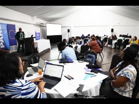 Participants at the Health National Adaptation Plan Stakeholder Consultation engage in a discussion on climate resilience strategies for Jamaica’s health sector.
