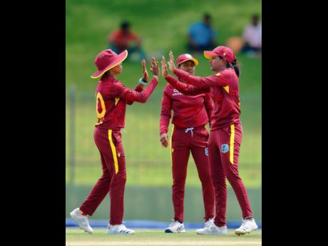 West Indies Women’s Kharishma Ramharack (right), Afy Fletcher (centre), and Shemaine Campbelle celebrate a Sri Lankan wicket during a cricket match between the two in Sri Lanka recently.