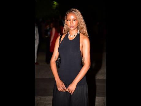 Stopping in to support her grandfather, Ambassador N. Nick Perry, American musician and actress Justine Skye was an understated beauty in this black Simon Miller dress.