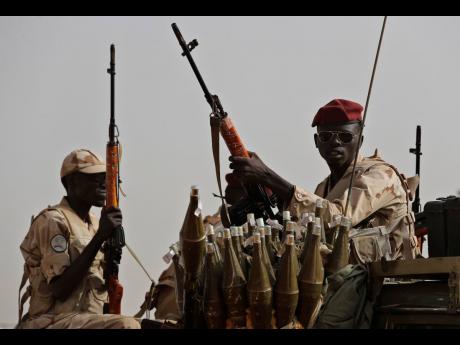 Sudanese soldiers from the Rapid Support Forces unit, led by General Mohammed Hamdan Dagalo, the deputy head of the military council, secure the area where Dagalo attends a military-backed tribe’s rally, in the East Nile province, Sudan