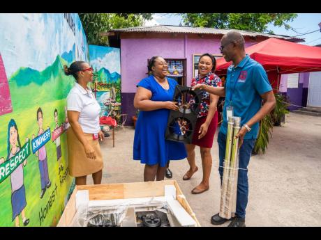 “I’m not going to cry this time Mr Beckford!” exclaimed Principal Sherica Francis-Christian as she accepted the remaining parts of the new appliance alongside Miss Sherry Gay
Watt. Addressing a critical need for the upcoming school year, D&G Foundati