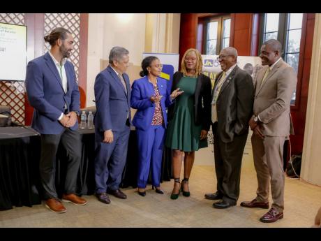Claudine Allen (third left), general manager of the JN Foundation,  makes a point to (from left) Jonathan Hernould, chief executive officer of Reef Construction Limited; David Wan, acting managing director of the Development Bank of Jamaica; Dr Charah Wats