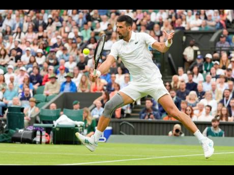 Credit: AP Serbia’s Novak Djokovic plays a backhand return to Vit Kopriva of the Czech Republic during their first-round match at the Wimbledon tennis championships in London yesterday.