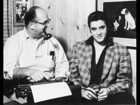 Credit: AP Tom Parker (left) of Madison, Tennessee, beams on protege Elvis Presley, January 7, 1957.