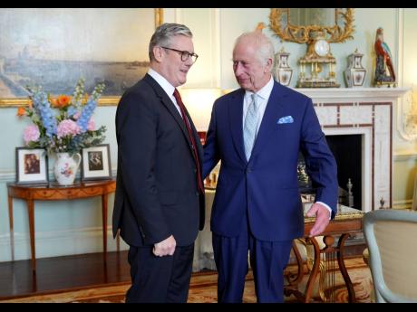Britain’s King Charles III (right), speaks with Keir Starmer where he invited the Labour Party leader to become prime minister and to form a new government, following the landslide general election victory for the Labour Party, in London yesterday.