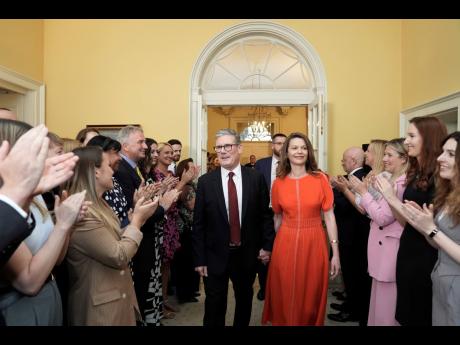 Britain’s newly elected Prime Minister Keir Starmer and his wife Victoria enter his official London residence at No 10 Downing Street for the first time after the Labour Party won a landslide victory in the 2024 general election, in London yesterday.