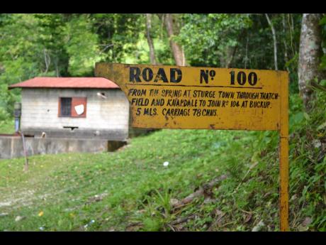 
An old sign shows the way to Thatchfield from the spring in Sturge Town.