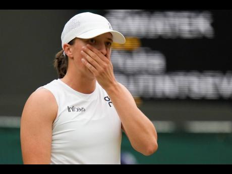 
Iga Swiatek of Poland reacts during her third-round loss to Yulia Putintseva of Kazakhstan at Wimbledon in London yesterday.
