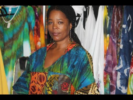 Fashion designer Simone Gordon of T&T Fashion is wearing her own creation against the backdrop of her batik clothes.