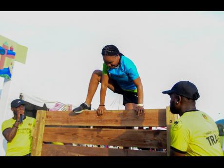 Credit: Antoine Lodge Representing Sagicor, Sabrina Johnson soared over another obstacle.