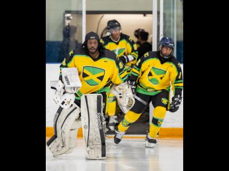 Credit: Contributed Giovani Smith leads Jamaica’s ice hockey team out onto the rink during a Challenger Series game played across, Chicago, New York, and Toronto.