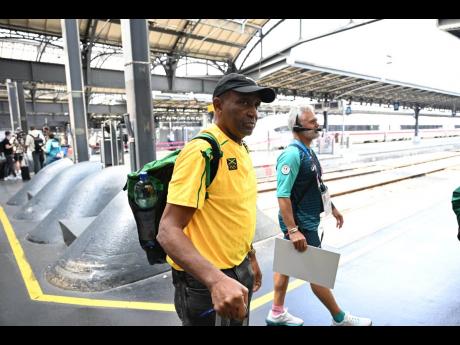 Jamaica’s track and field team manager, Ludlow Watts, arrives at Gare de l’Est in Paris, France, yesterday.