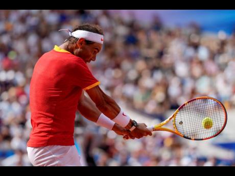 Rafael Nadal of Spain returns the ball against Marton Fucsovics of Hungary during the men’s singles tennis competition at the 2024 Summer Olympics  in Paris, France yesterday. 