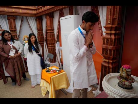 Hindu religious representative Pavitra Patel prays inside the Hindu room at the Multifaith Center in the Olympic Village, at the 2024 Summer Olympics in Paris, France.