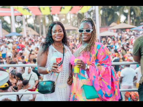  Amid the beach fête, Rum Stripe junior brand manager Cavell Robinson (left) and brand manager Jodi-Ann Campbell paused to capture the moment.