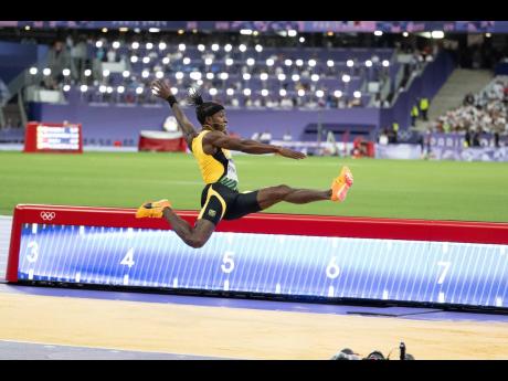 Wayne Pinnock launches himself during his silver-medal-winning run in the men’s long jump at the Stade de France yesterday.
