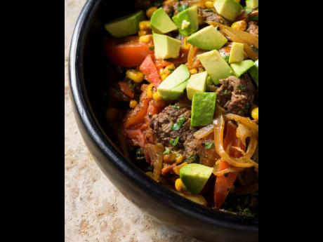 The Chilean beef with tomato and corn sauté is topped with the avocado and served with lime wedges.