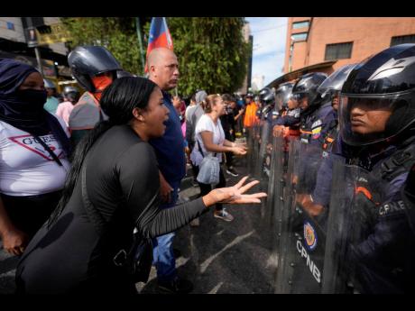Protesters face off with police during demonstrations against the official election results declaring President Nicolás Maduro’s reelection, the day after the vote in Caracas, Venezuela.