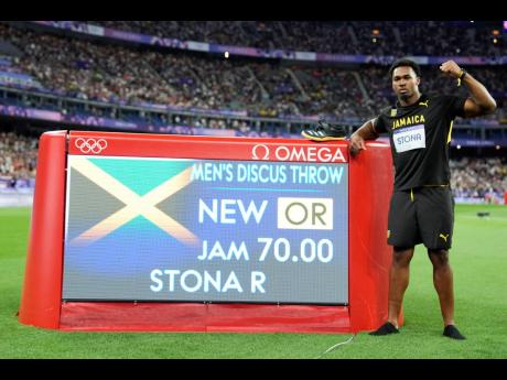 Roje Stona, of Jamaica, celebrates after winning the men’s discus throw final at the 2024 Summer Olympics, Wednesday, August 7, in Saint-Denis, France. 