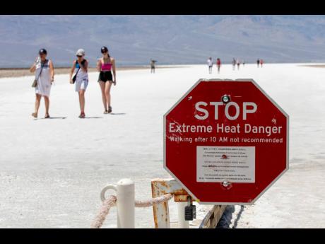 
A stop sign warns tourists of extreme heat at Badwater Basin, in Death Valley National Park, California. 