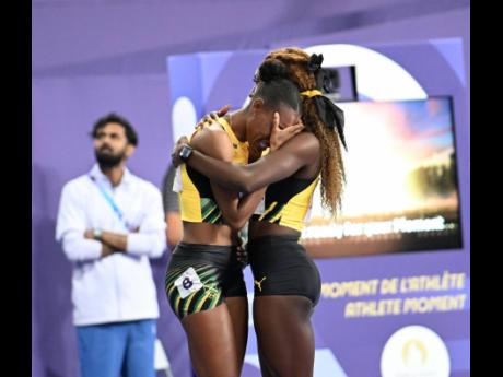 Shiann Salmon (right) gives a shoulder to Stephenie-Ann McPherson, who never had a chance to run in her final Olympic Games.