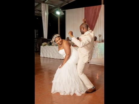 Credit: Meikle Meiks Photography Pedrine and Kenroy enjoy a festive dance as husband and wife.