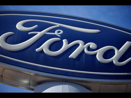 Credit: AP A Ford company logo on a sign at a Ford dealership in southeast Denver.