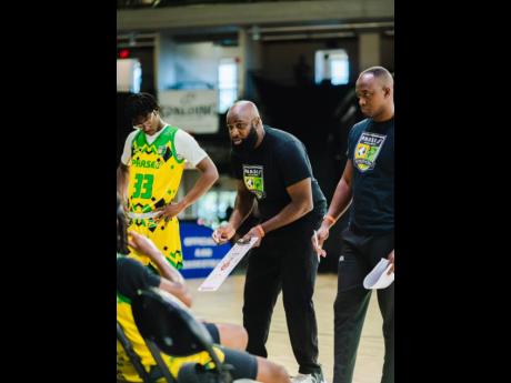 Credit: Contributed Wayne Dawkins (centre) , CEO of P.H.A.S.E 1 Academy, speaking to his players at the Orlando AAU Nationals in Orlando, Florida on July 3-5. Looking on at right is assistant coach Dave Black.