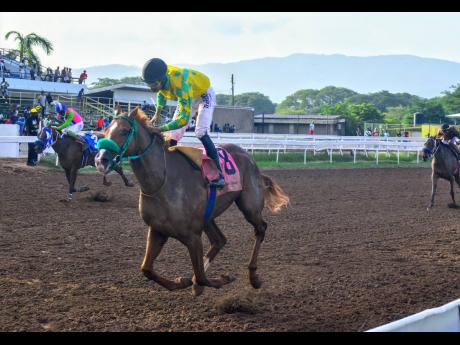 
ATLANTIC CONVOY, ridden by Reyan Lewis, wins the ninth race, The 20th running of the Arthur Jones Memorial Trophy, Division I, Overnight Allowance for horses, three years old and upwards over six furlongs at Caymanas Park yesterday.